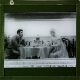 [Man and woman sitting at table]