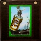 [Workman on oversized cocoa tin carried by crane]