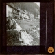 [Sequence of water mills in Alpine landscape]
