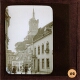 [Street scene with clock tower in unidentified city]