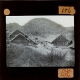 [Group of buildings in walled enclosure in hilly landscape]