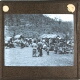 [Group of people at settlement in hilly landscape]