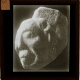 [Stone carving showing human head]
