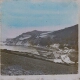 [Sea inlet and headland with houses]