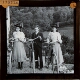 [Two girls and boy holding bicycles]