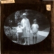 [Woman, boy and girl standing in garden]