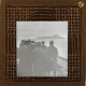 [Group of men looking at coastline from ship]
