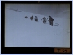 slide image -- [The excursion group descending a mountain covered in snow]