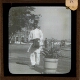[Man carrying briefcase in unidentified town or city]