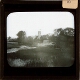 [Church and houses in marshland landscape]