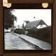 [Thatched cottage at side of lane]