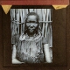 [African person with necklace and arm adornments]
