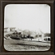 [Undentified village street, stream and houses]