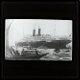 [Passenger steamship surrounded by small boats]