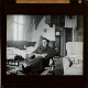 [Wounded soldier sitting in chair in room used as hospital ward, Alderley Park]