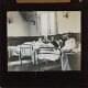 [Three wounded soldiers in beds in room used as hospital ward, Alderley Park]