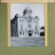 [Large building with tower and dome in unidentified town or city]