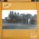 [Railway locomotive being loaded with firewood]